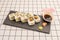 sushi uramaki dragon roll stuffed with shrimp in tempura with ripe avocado, wasabi, ginseng and soy sauce