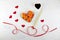 Sushi for Valentines Day in a heart-shaped plate on white wooden background. Sticks with a red ribbon, decorations-hearts.