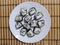 sushi on a white plate, striped background, interlacing, for postcards, for business cards, for the menu