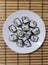 sushi on a white plate, striped background, interlacing, for postcards, for business cards, for the menu