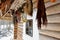 Suspended bunches of dried herbs at porch of an old wooden cottage