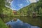 Suspended cottage near pond with small pontoon