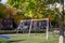 Suspended modern swing on the playground. Soft lawn covering