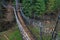 Suspended wooden bridge over a mountain stream.