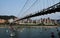 Suspension bridge cross the river and small boats