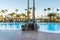 A suspension bridge hanging over a hotel pool leading between the