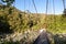 Suspension bridge linking two sides of a valley in the mountains