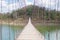 suspension bridge stretches through the middle of lake Kaeng Krachan tourist area in Thailand. this image for nature, landscape