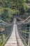 Suspension bridge view on pedestrian walkway on mountains