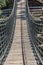 Suspension bridge view on pedestrian walkway on mountains