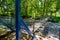 Suspension footbridge spans the river with waterfall.