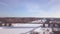 Suspension railway bridge for train traffic over frozen river on winter landscape aerial view. Car traffic on winter