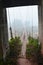 Suspension wooden bamboo bridge in forest for people crossing small stream