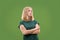 Suspiciont. Doubtful pensive woman with thoughtful expression making choice against green background