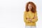 Suspicious, alarmed and distressed redhead curly girlfriend in yellow sweater, frowning and squinting as stare with