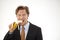 Suspicious businessman eating banana