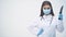 Suspicious young female doctor in medical mask appearing on the white background with big sharp knife in her hand