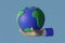 Sustain earth / Earth day concept: Cartoon style hands model holding a planet earth on blue background. 3d illustration