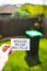 Sustainability and circular economy, reduce reuse recycle sign in front of backyard bokeh with garbage bin in the background