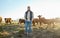 Sustainability, farming and portrait of man with cows on field, happy farmer in countryside with dairy and beef