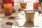 Sustainable food delivery package with wooden spoon on kitchen table with sunlight, shadows, candle, pumpkin and seasonal