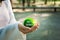 sustainable living with a hand holding a green ball, reflecting environmental