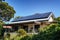 Sustainable Modern Living: Solar Panels Grace Gable Roof in Sunlit Brilliance