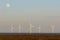 Sustainable resource. Offshore wind turbines generating electricity night and day