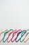 Sustainable responsible consumption concept. Many bright multi-colored velvet pop color hangers on white background. Store, sale,