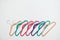 Sustainable responsible consumption concept. Many bright multi-colored velvet pop color hangers on white background. Store, sale,