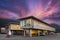 Sustainable wood office building on pillars with parking spaces underneath