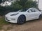 Sutton Suffolk UK August 12 2021: A 2019 model Tesla Model 3 Long-Range Dual Motor AWD electric vehicle parked in a small