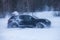 SUV car drifting in snow, during competition, sport car racing drift on snowy race track in winter