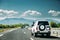 SUV Car Driving In Motorway Highway Freeway Road With Mountains Landscape On Background. Auto Travel Trip Concept