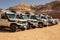 SUV car expedition  in a stone desert of Egypt.  Mountain landscape with offroad vehicle.