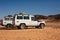 SUV car expedition  in a stone desert of Egypt.  Mountain landscape with offroad vehicle.