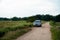 SUV car Honda BRV driving on gravel road or offroad in between paddy fields, Sawah Ring, Malaysia