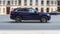 SUV car Jaguar F-Pace fast drive on asphalt road in Moscow city. Jaguar F-Pace is the first Sport Utility Vehicle made by British