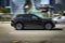 SUV car Jaguar F-Pace fast drive on urban asphalt road. Jaguar F-Pace is the first Sport Utility Vehicle made by British sports