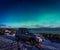 SUV car in the parking place under northen lights in Atlantic Ocean Road