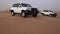 SUV at the top of the dune in the Rub al Khali desert, the wind chases the sand stock footage video