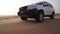 SUV at the top of the dune in the Rub al Khali desert, the wind chases the sand stock footage video