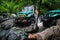 SUV in the tropical jungle - March 7, 2013 Adventure car enthusiast wading a rocky river using modified four wheel car