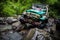 SUV in the tropical jungle - March 7, 2013 Adventure car enthusiast wading a rocky river using modified four wheel car