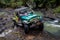 SUV in the tropical jungle - March 7, 2013 Adventure car enthusiast wading a rocky river using modified four wheel car