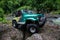 SUV in the tropical jungle - March 7, 2013 Adventure car enthusiast wading a rocky river using modified four wheel car