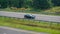 Suzuki baleno sedan driving fast on trans Jawa highway