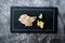 Suzuki Fish Sashimi with Pickled Ginger and Wasabi on Black Stone Board