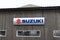Suzuki sign text and brand logo vehicle shop car motorcycle dealership motorbike