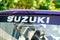 Suzuki sign text on vehicle rear window glass car with brand logo of japanese company